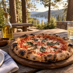 Wood-fired pizza on a picnic table among the pines
