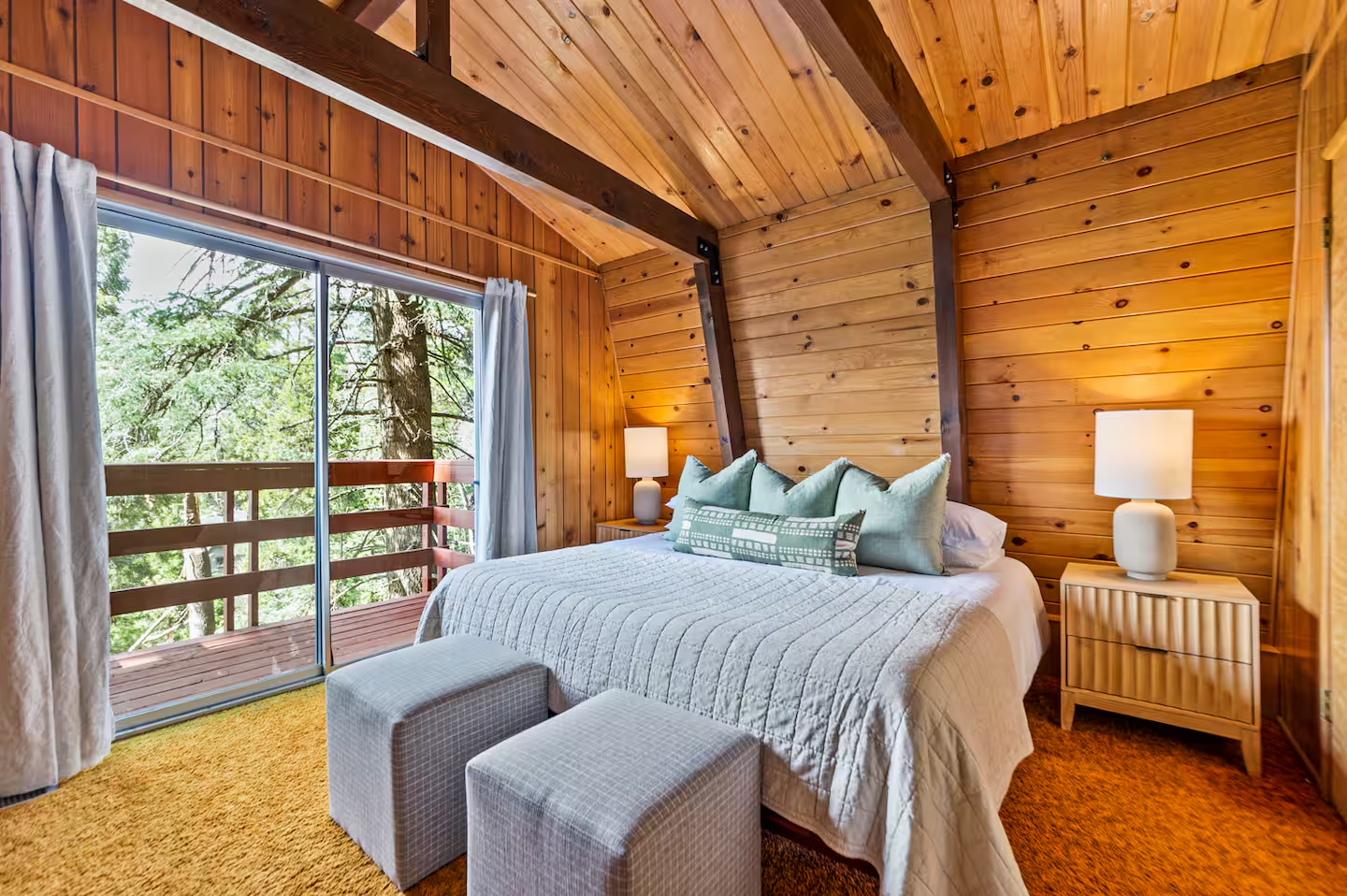 Warm private cabin bedroom with forest views