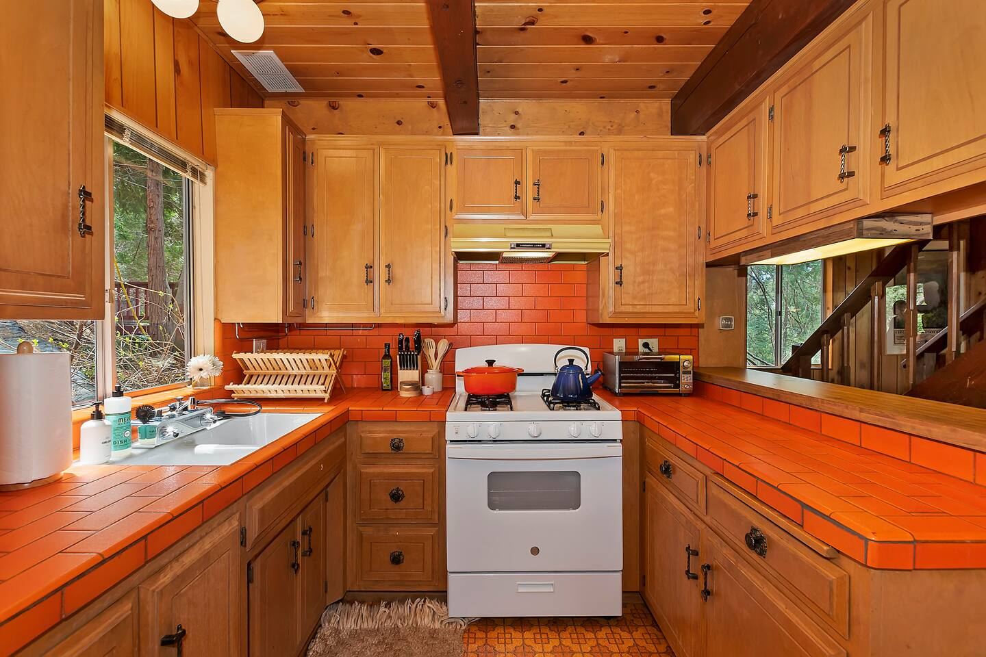 Full cabin kitchen with warm wood cabinetry